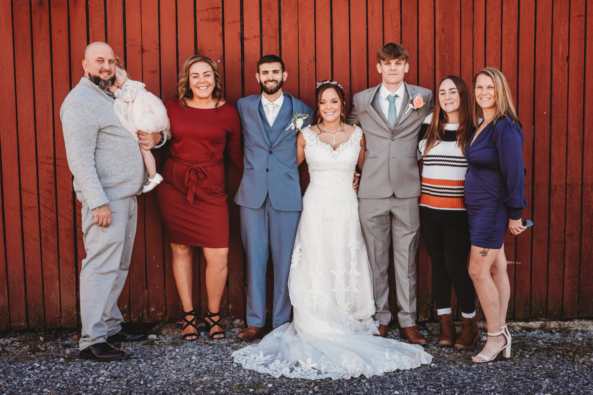 Wedding photo of family against barn.