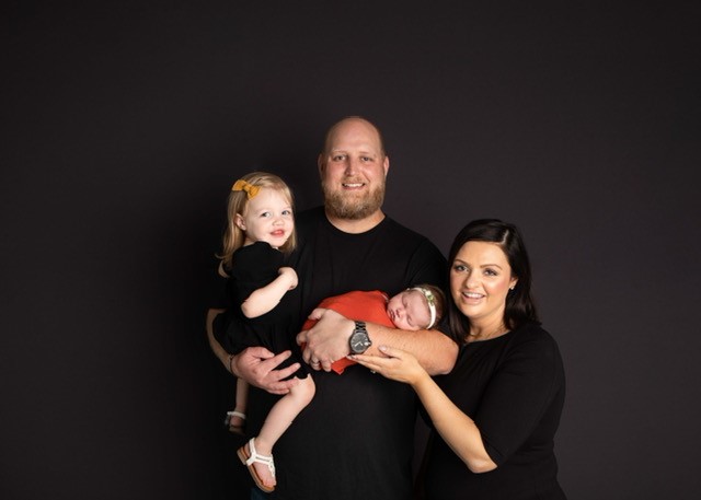 Family portrait of Christa Jensen, husband, and two daughters