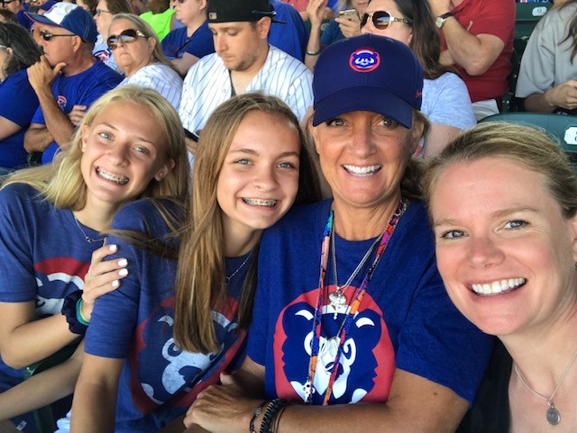 Four women smiling at Cubs game