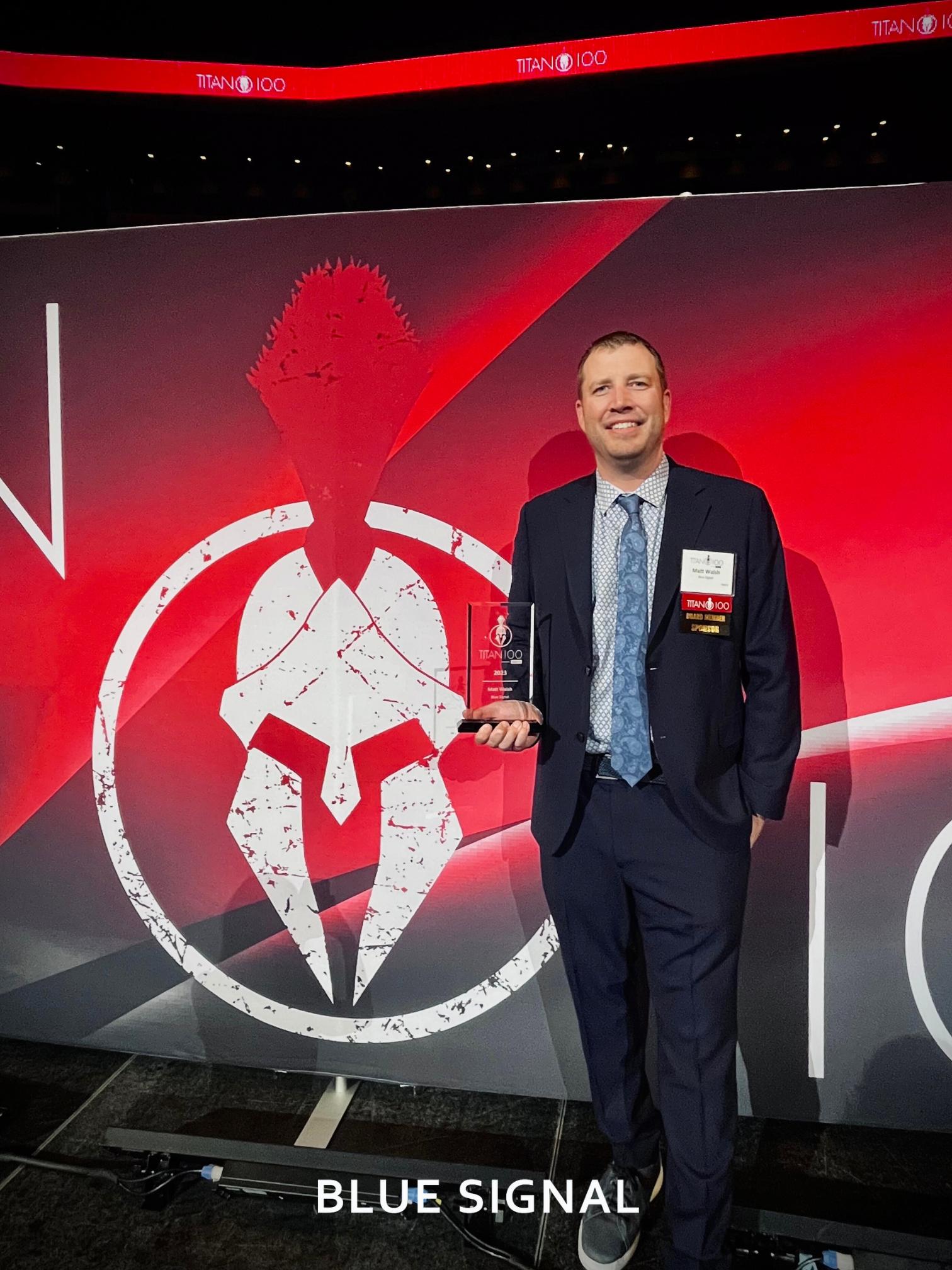 Blue Signal CEO, Matt Walsh holding his trophy at the Phoenix Titan 100 ceremony event hosted at the Desert Diamond Casino in Glendale, AZ.