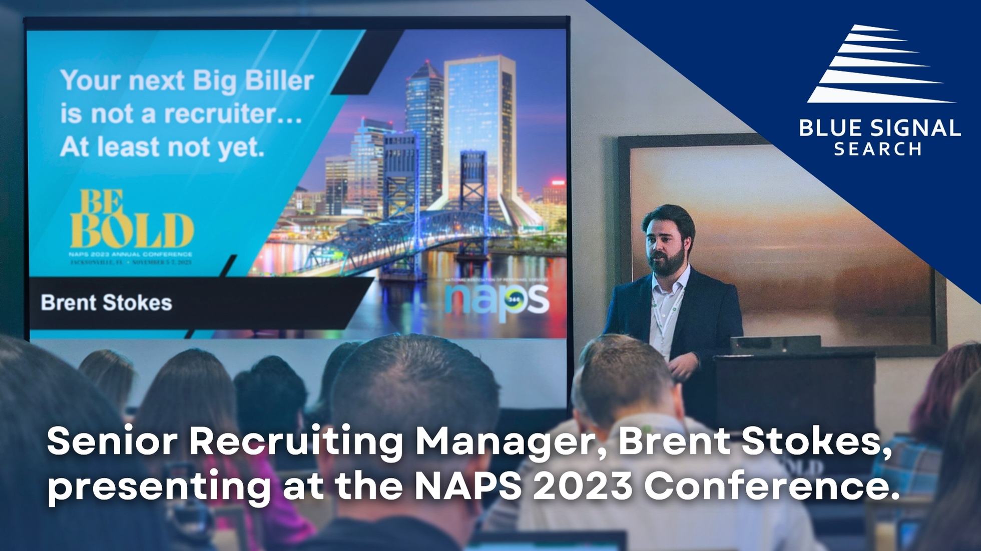 Blue Signal recruiter Brent Stokes giving a presentation at the NAPS 2023 Conference, with a screen behind him displaying the message 'Your next Big Biller is not a recruiter... At least not yet. BE BOLD' and the Jacksonville, FL skyline.