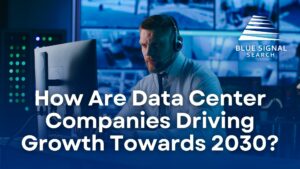 Man working in a data center with the blog title "How Are Data Center Companies Driving Growth Towards 2030?"