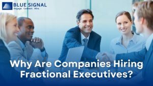 Business professionals in a meeting, discussing the advantages of hiring fractional executives. The text reads 'Why Are Companies Hiring Fractional Executives?