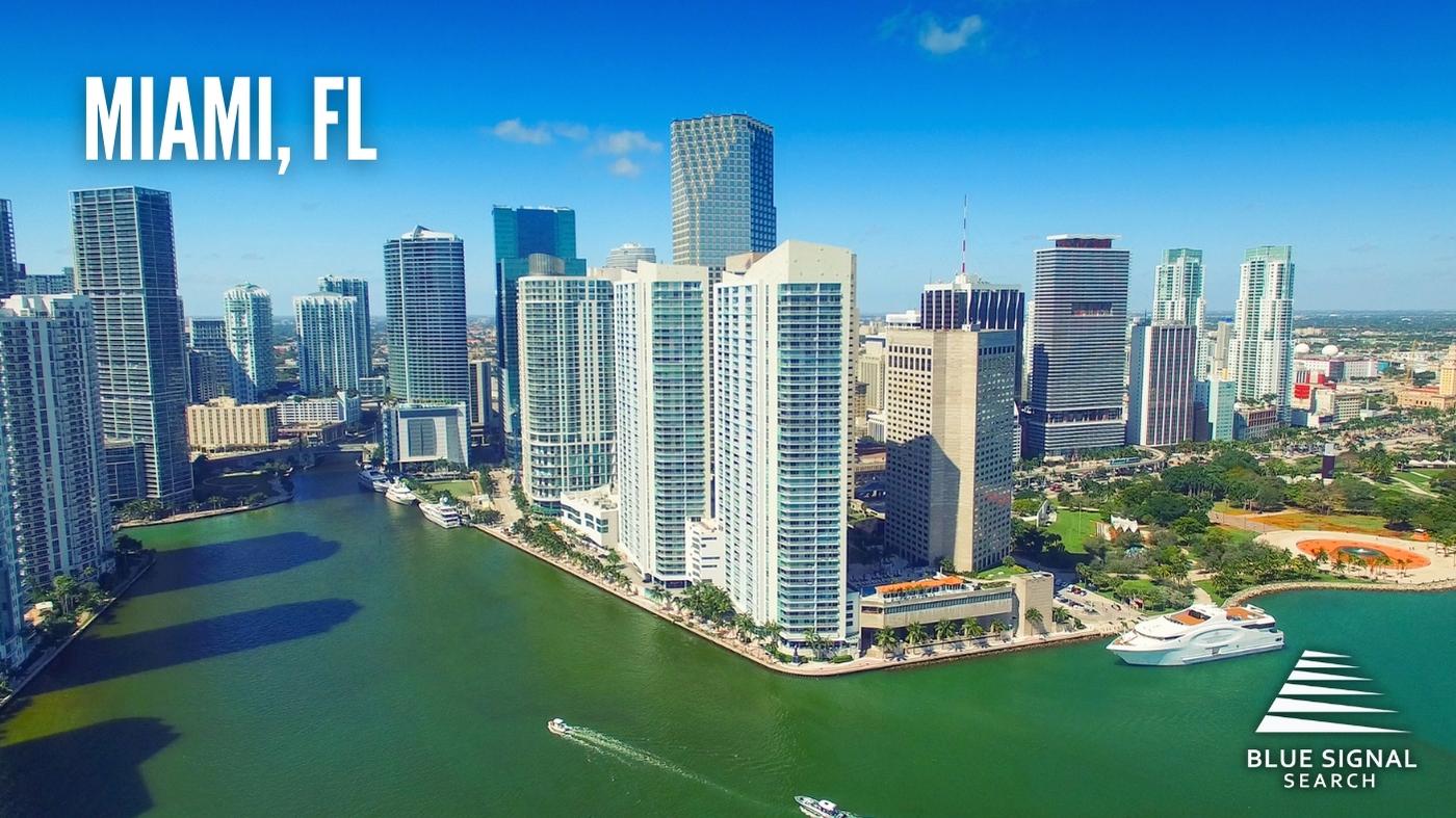 Aerial view of downtown Miami, FL, with modern skyscrapers along the waterfront.