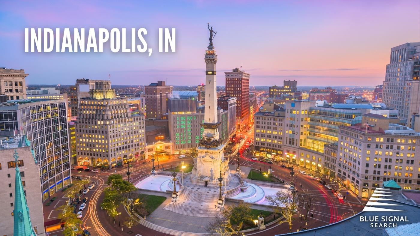 Aerial view of downtown Indianapolis, IN, at dusk, with the Soldiers and Sailors Monument in the center.