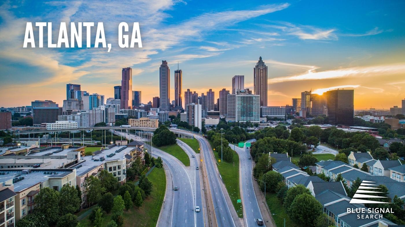 Aerial view of downtown Atlanta, GA, at sunset with highways leading into the city