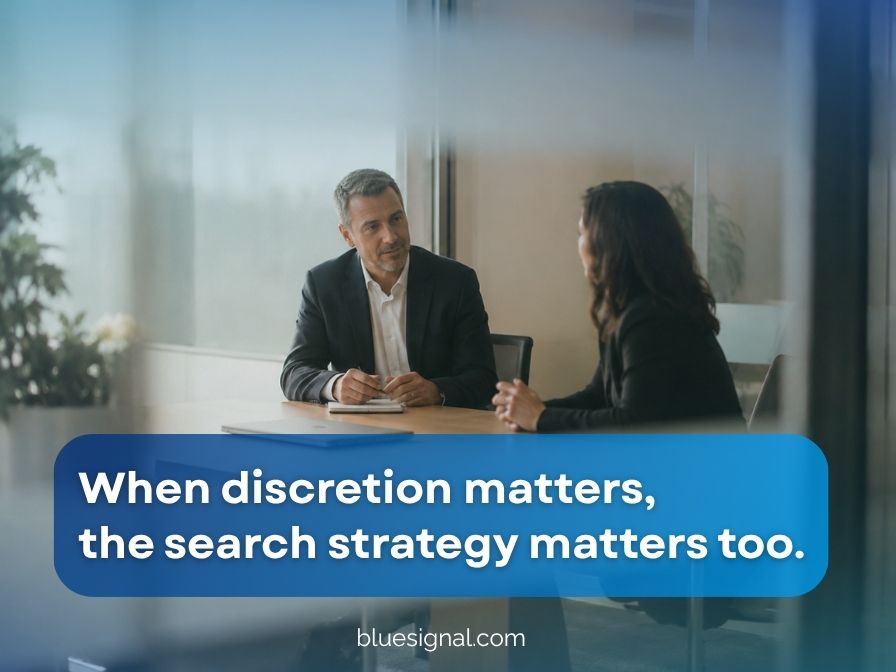 Confidential executive search meeting between two business leaders in a private office