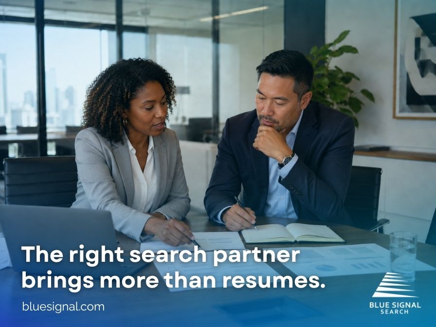 Executive search firm reviewing candidate profiles and hiring strategy with a business leader