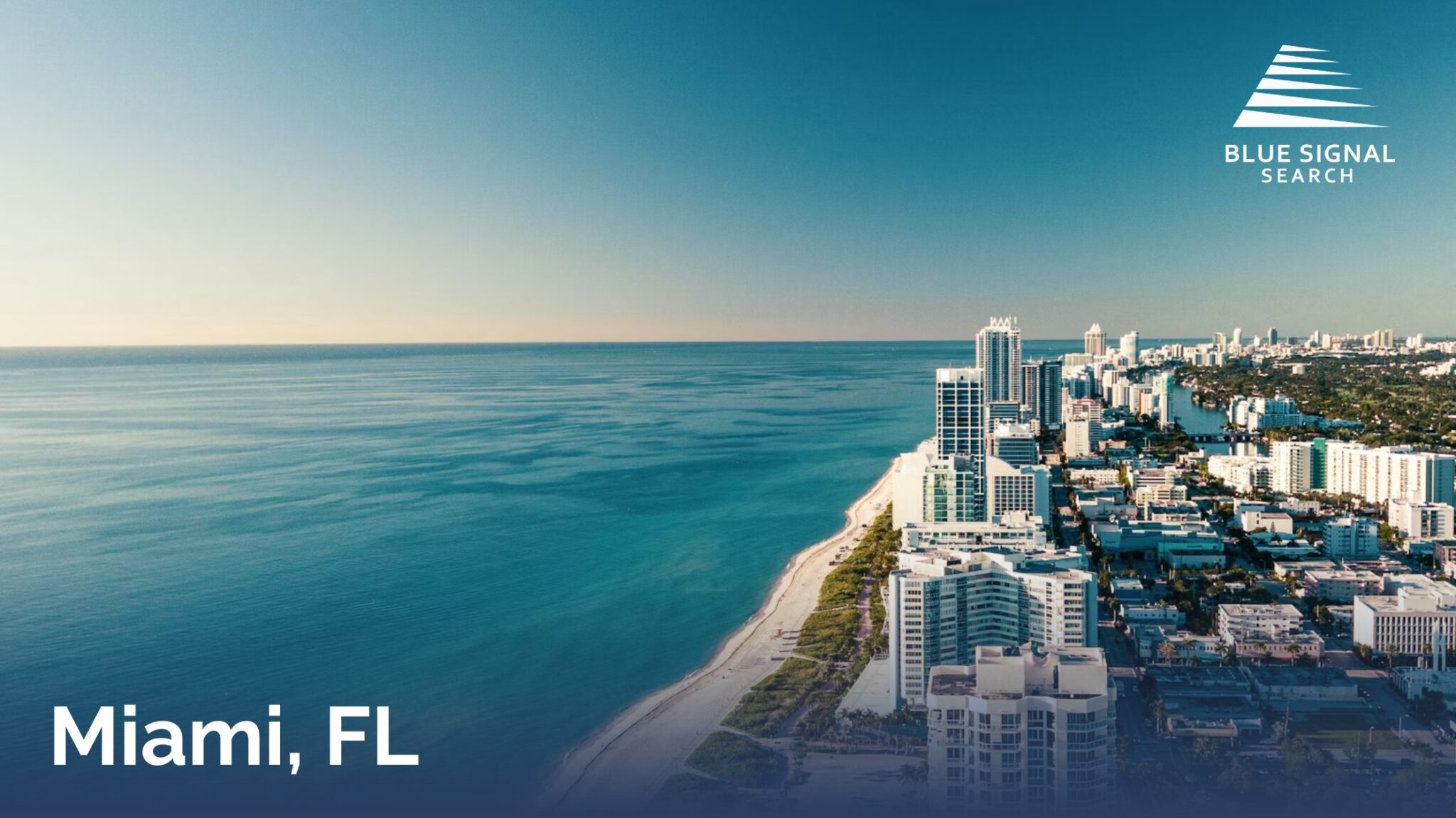 Aerial view of Miami Beach coastline with high-rise buildings and the Atlantic Ocean.