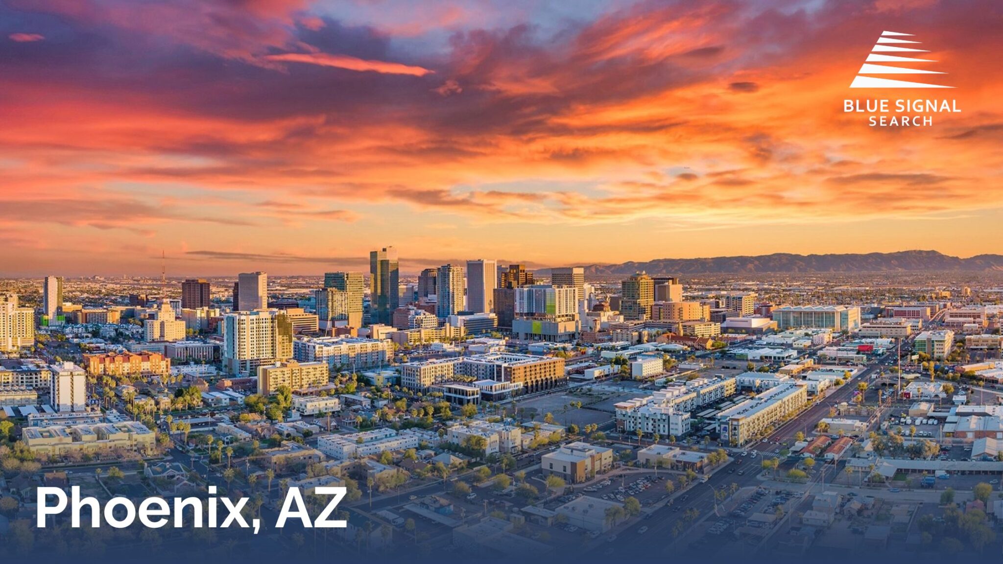 Downtown Phoenix skyline at sunset with colorful skies and surrounding cityscape.
